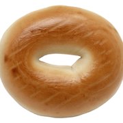 A freshly baked bagel displayed against a clean white background, highlighting its golden-brown crust and round shape